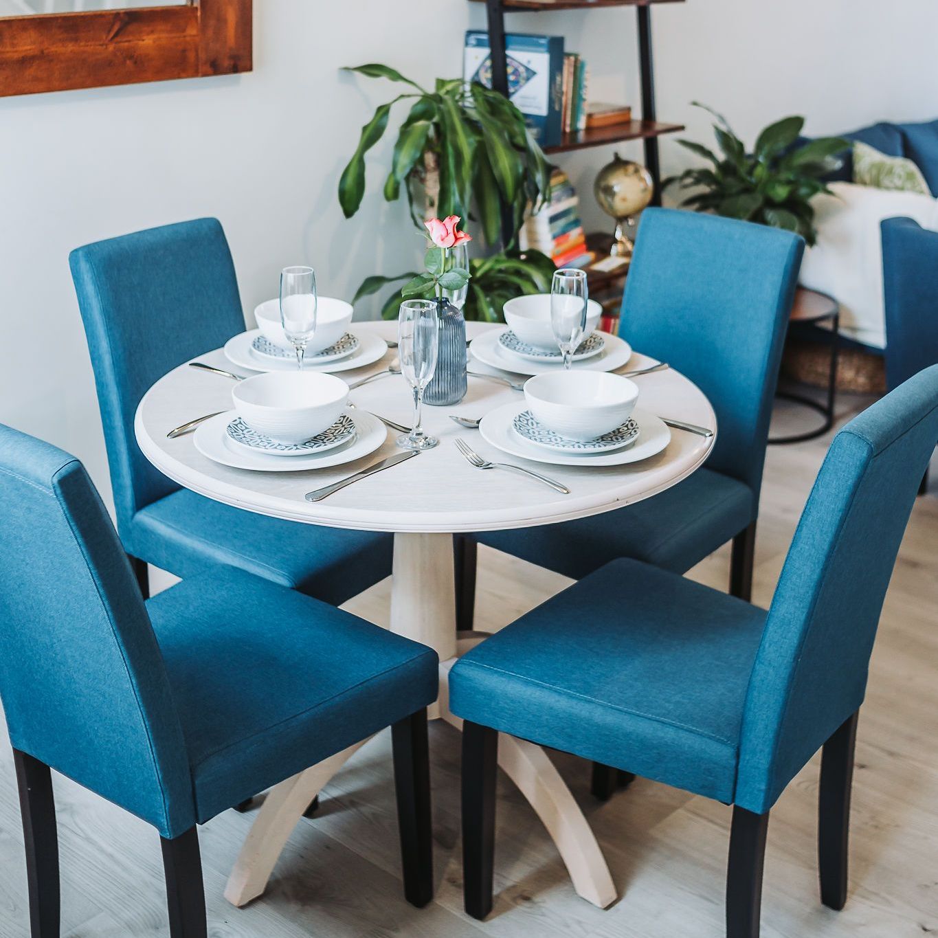 dining table surrounded by four blue chairs