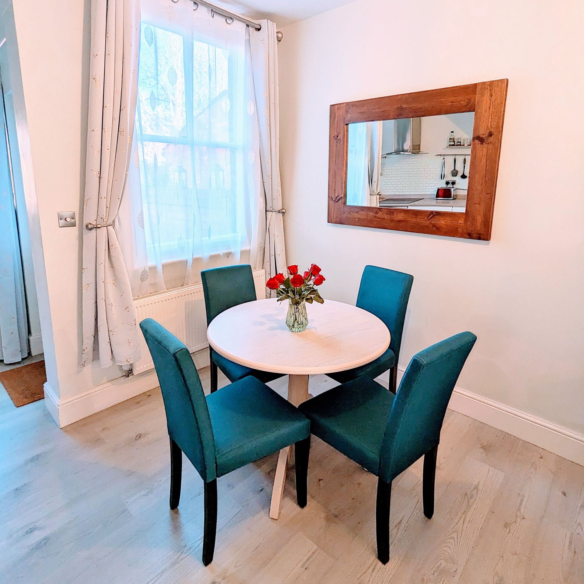 dining area with large reflective mirror and large sash window