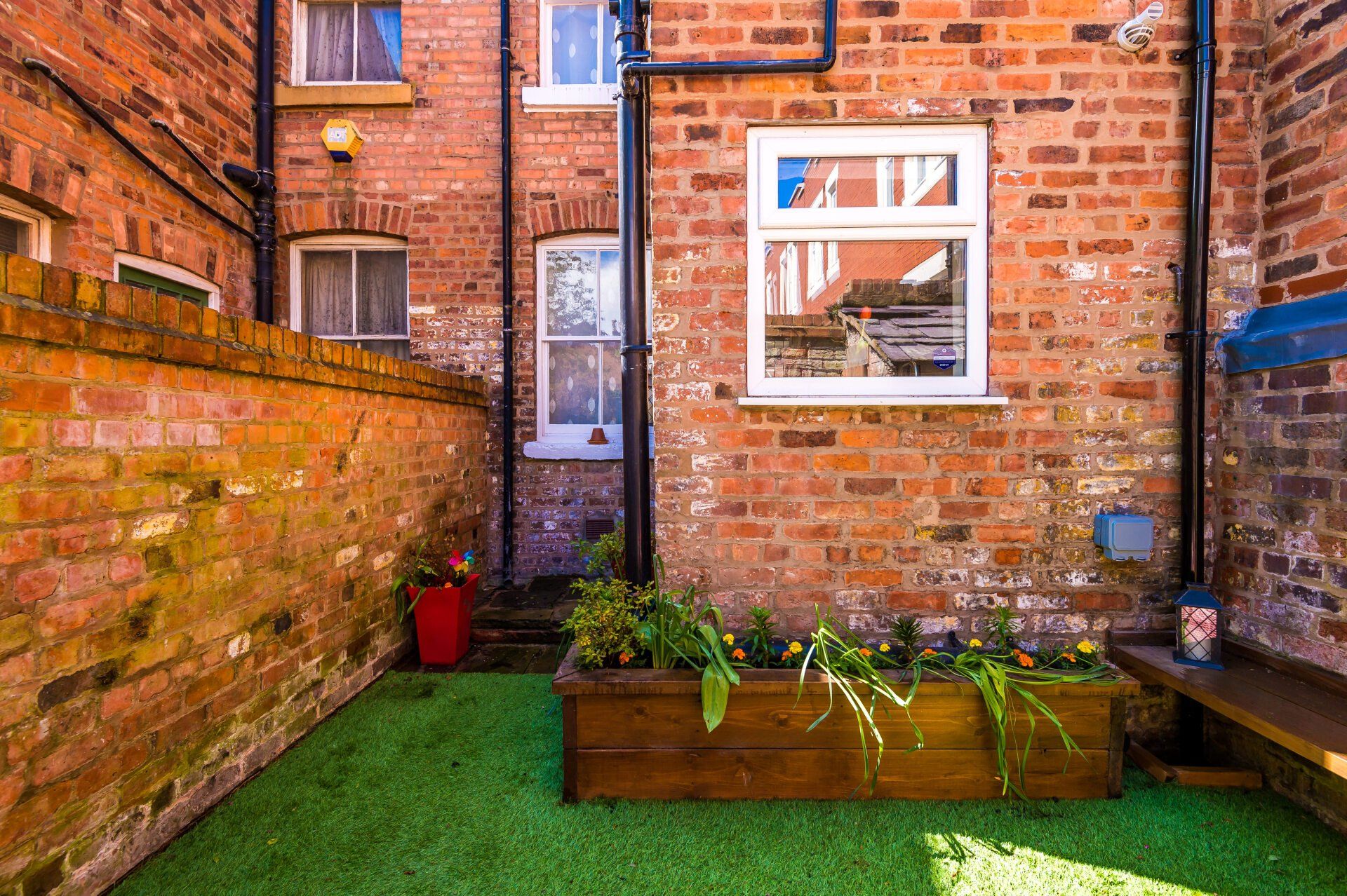 AstroTurf area with raised wooden planters