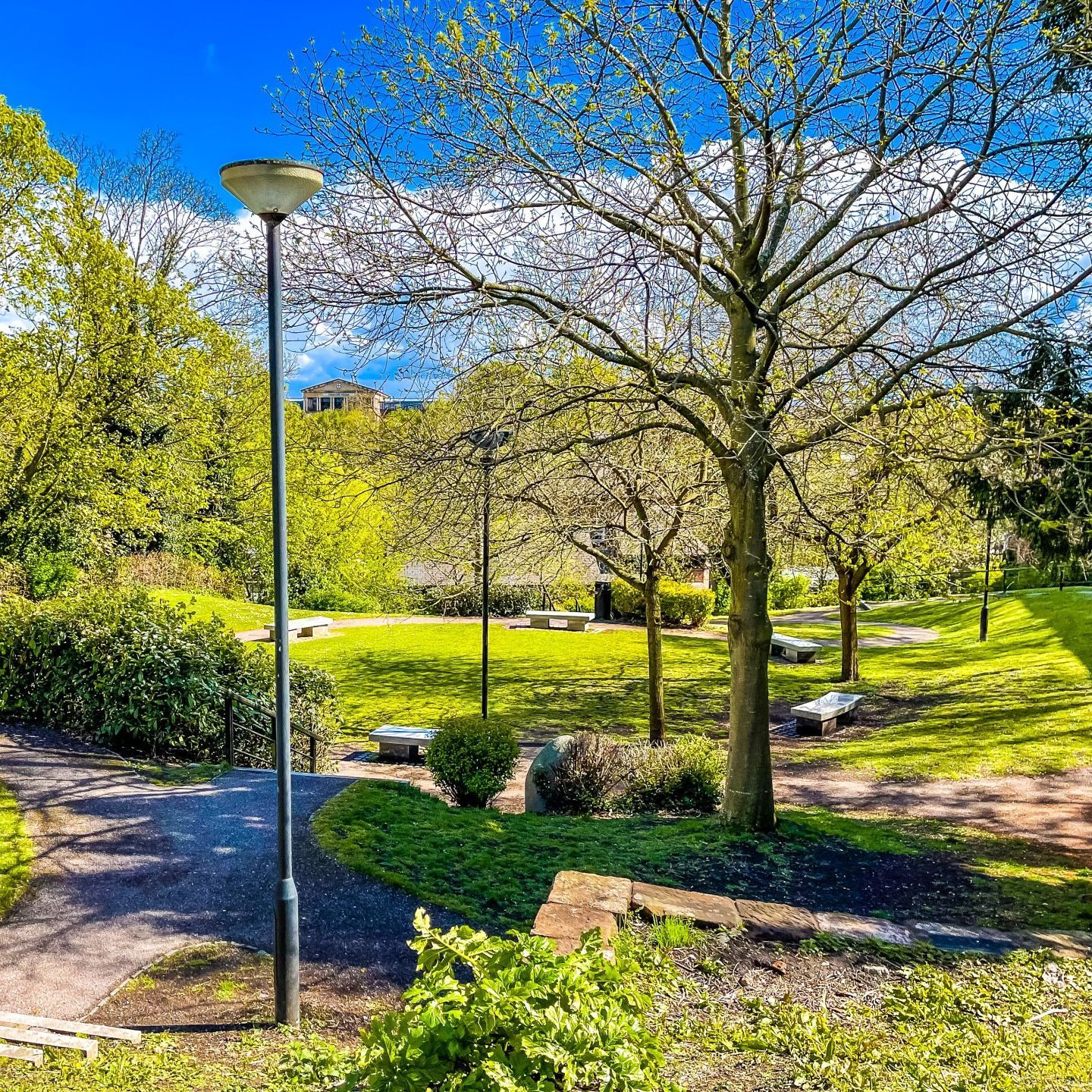 sunny roman gardens with paths cutting through green grass