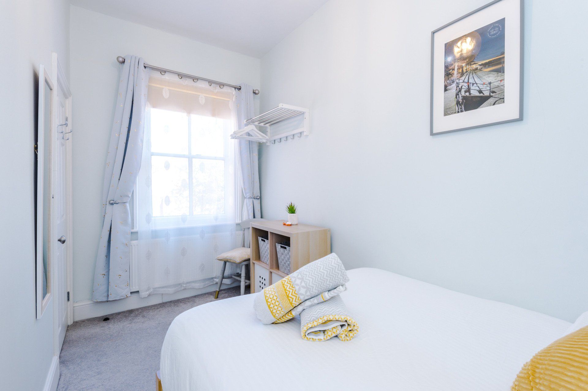 storage and clothes rail in second bedroom