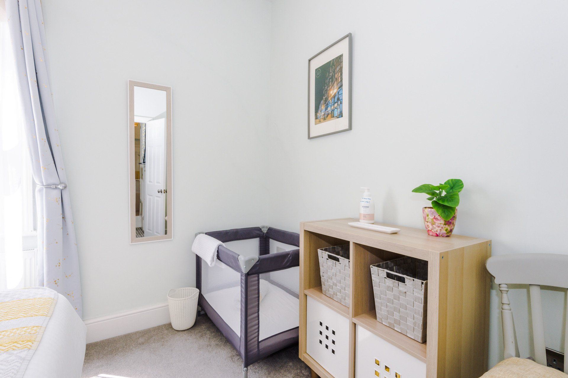 main bedroom with travel cot