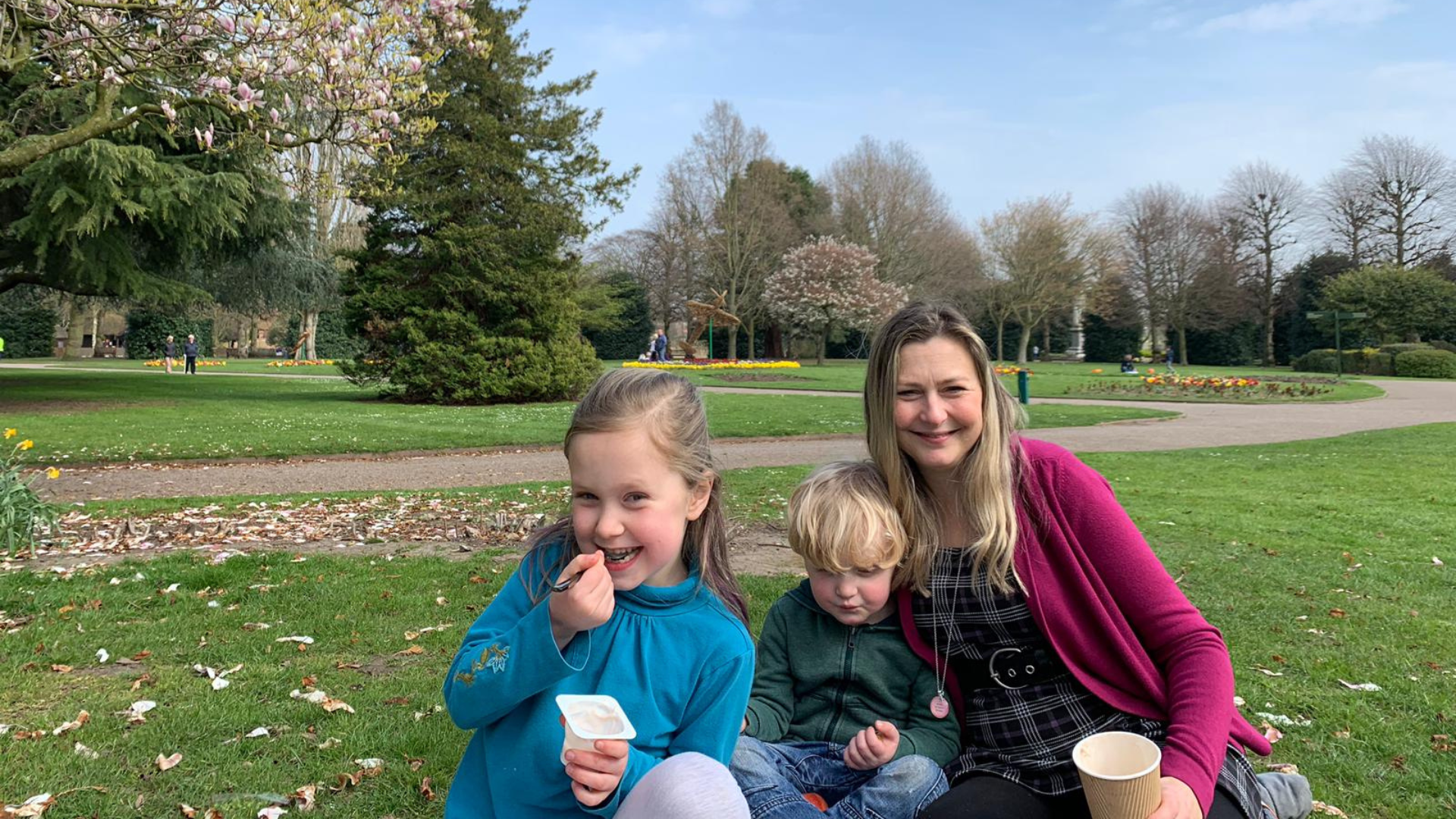 sun tent set up on the grass with two children in it
