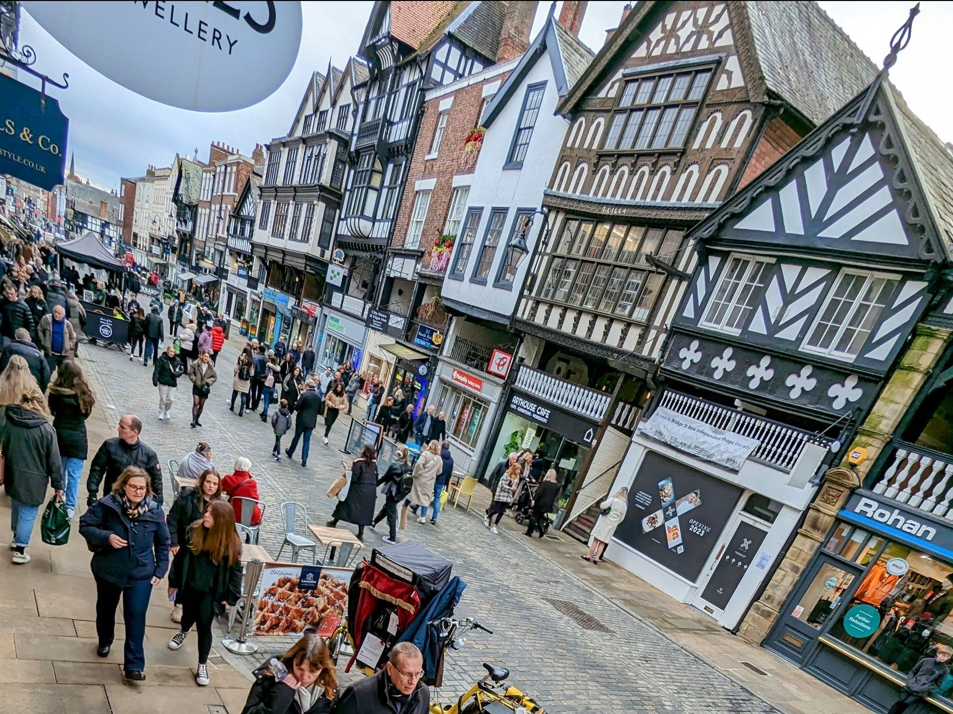 shoppers on bridge street with balck and white buildings