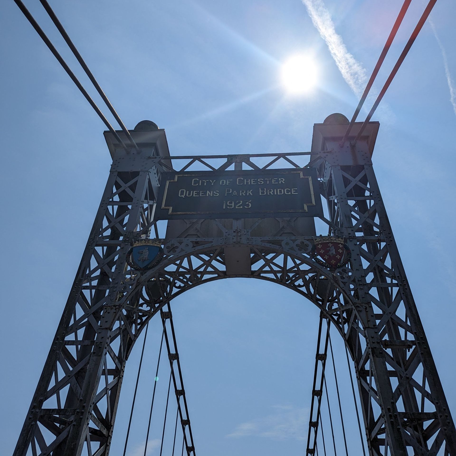 sun over the iron suspension bridge