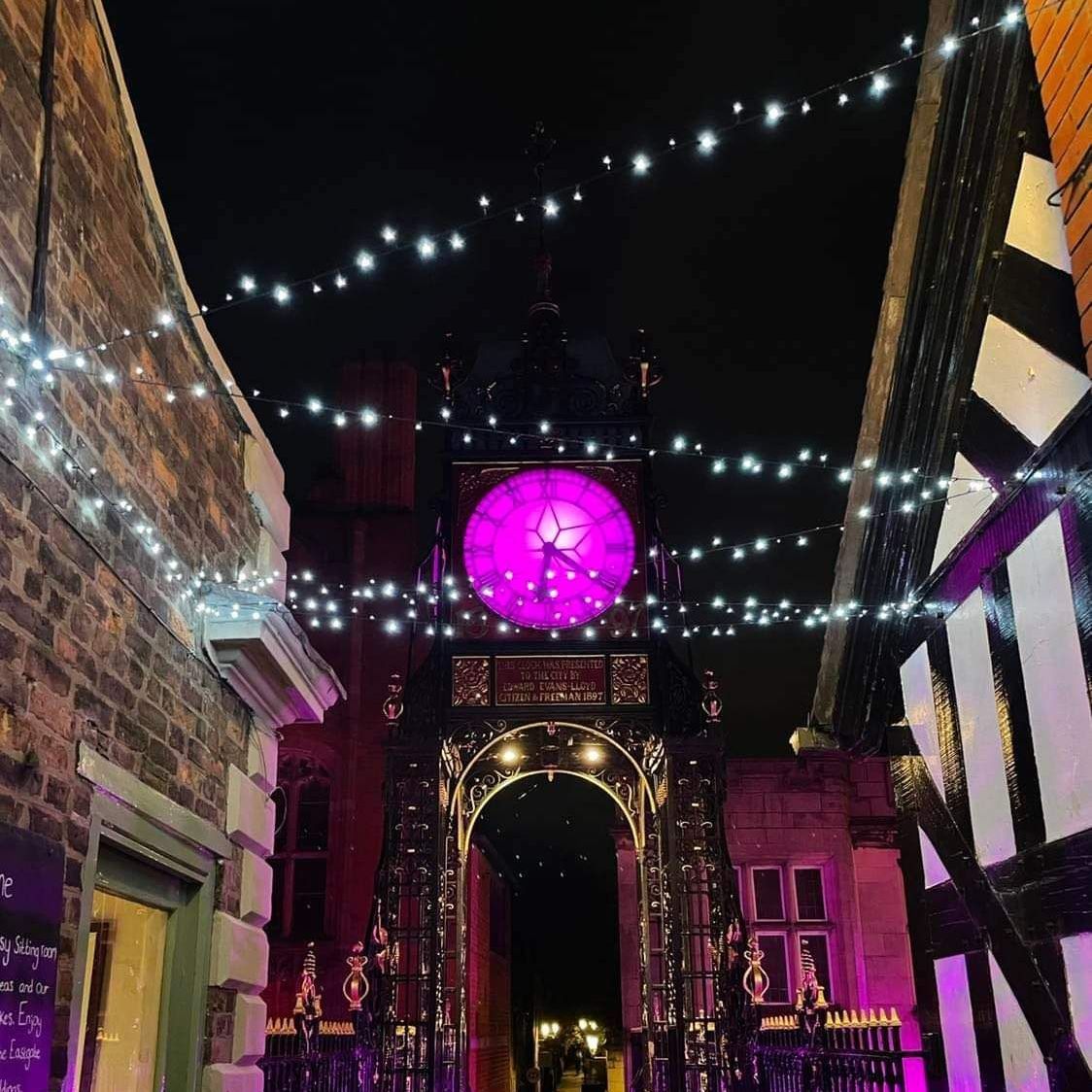 chester cross in the centre of the shopping area covered in christmas lights