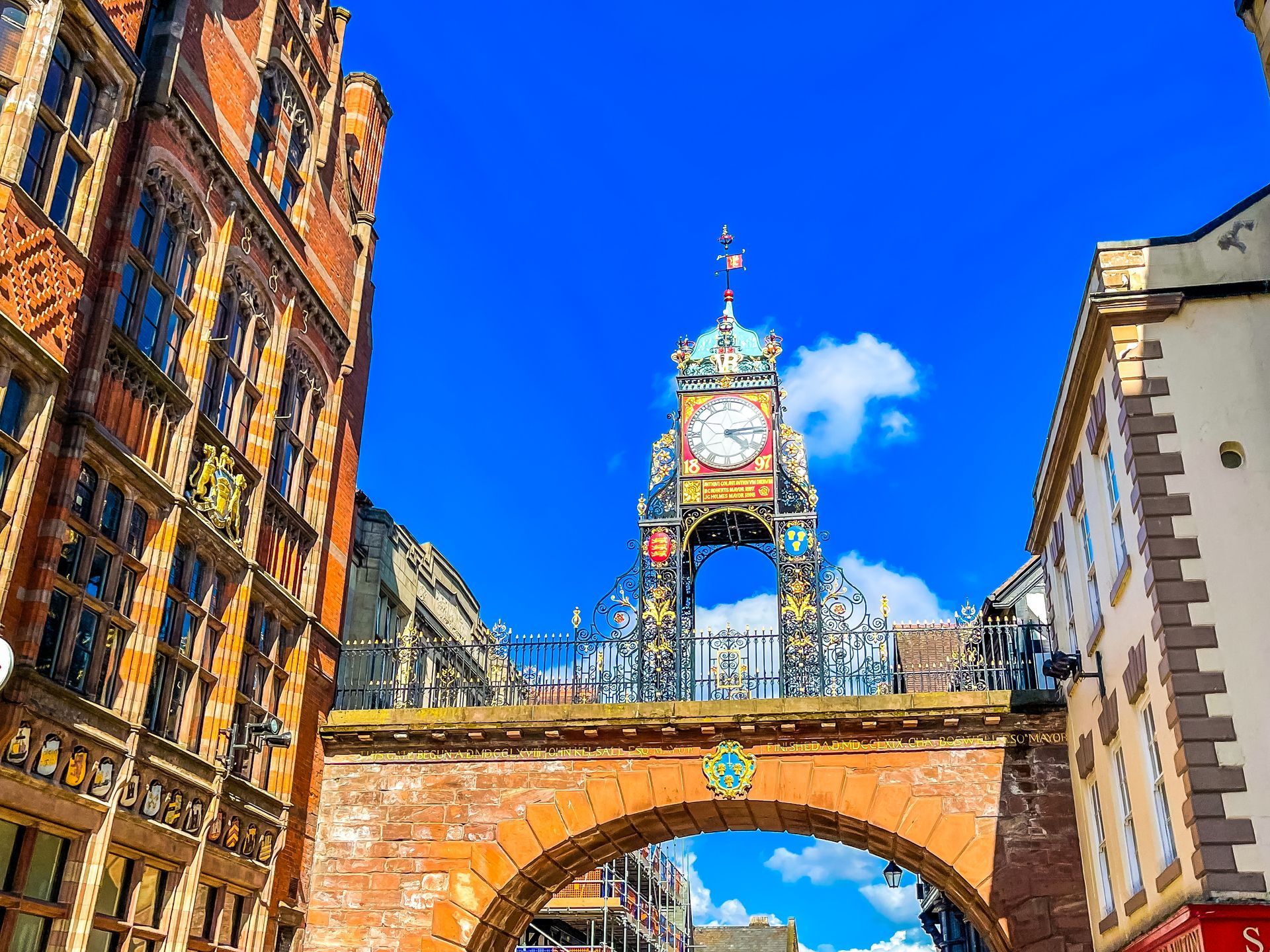 looking up at the eastgate clock on the rows on a summers day with bright blue sky