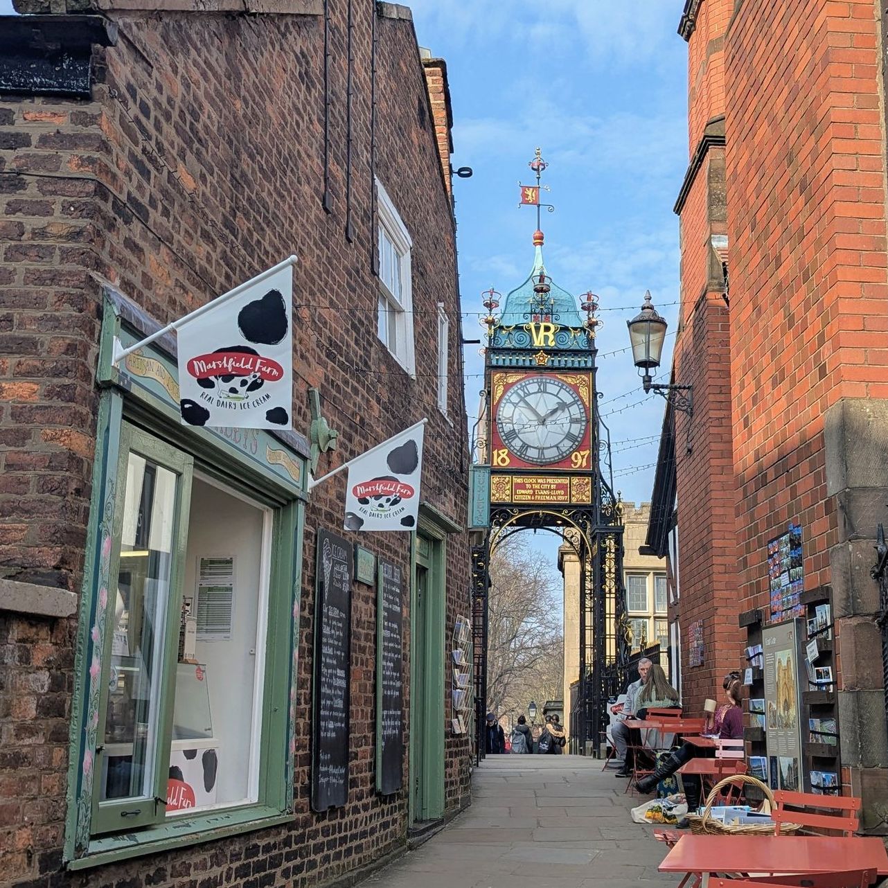 a guided walking tour of the city centre with a group resting at a cafe listening to the guide