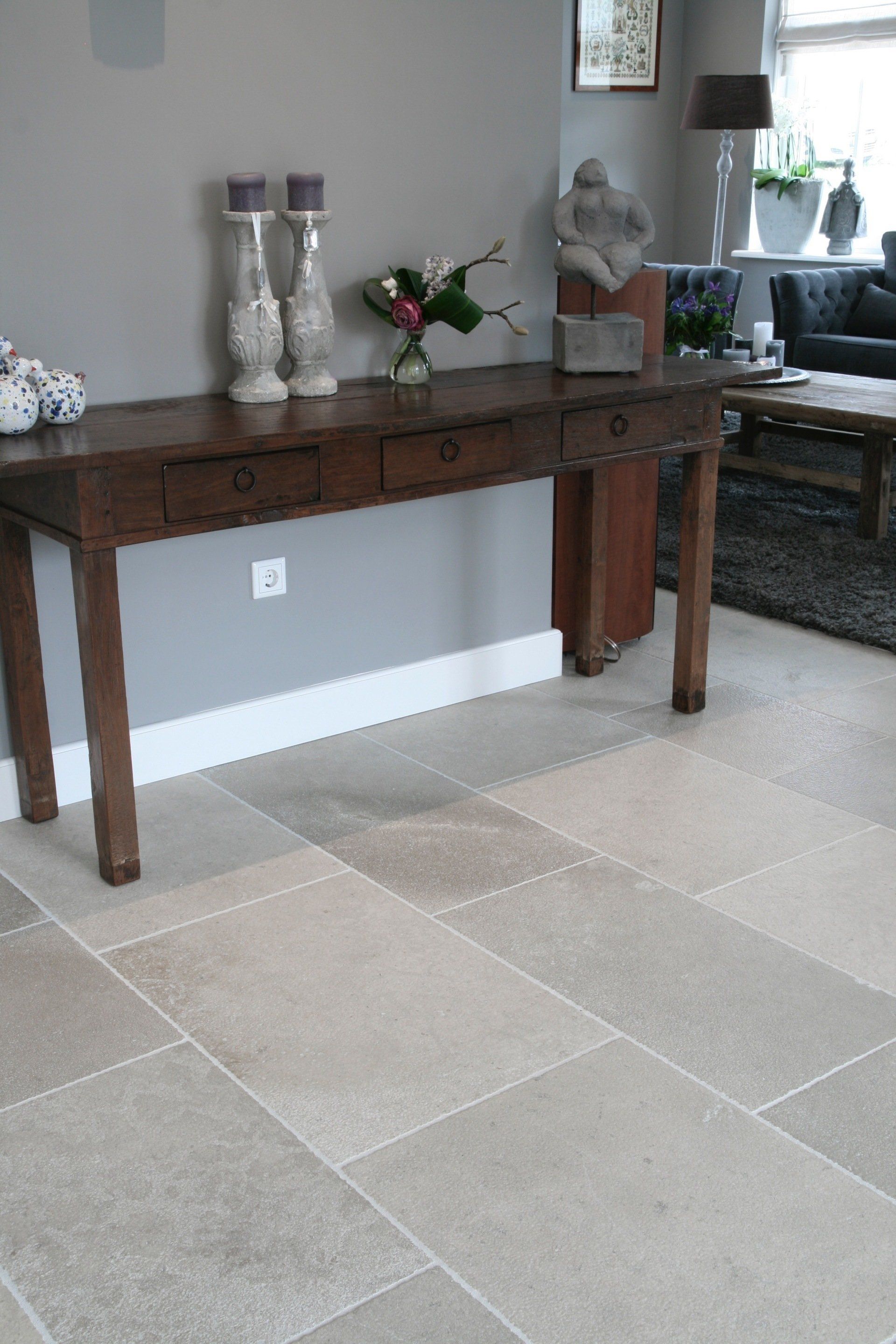 Eleganter Natursteinboden Wohnzimmer in Graubeigenuancen schlichtes Design Burgunderstein gemischte Nuancen