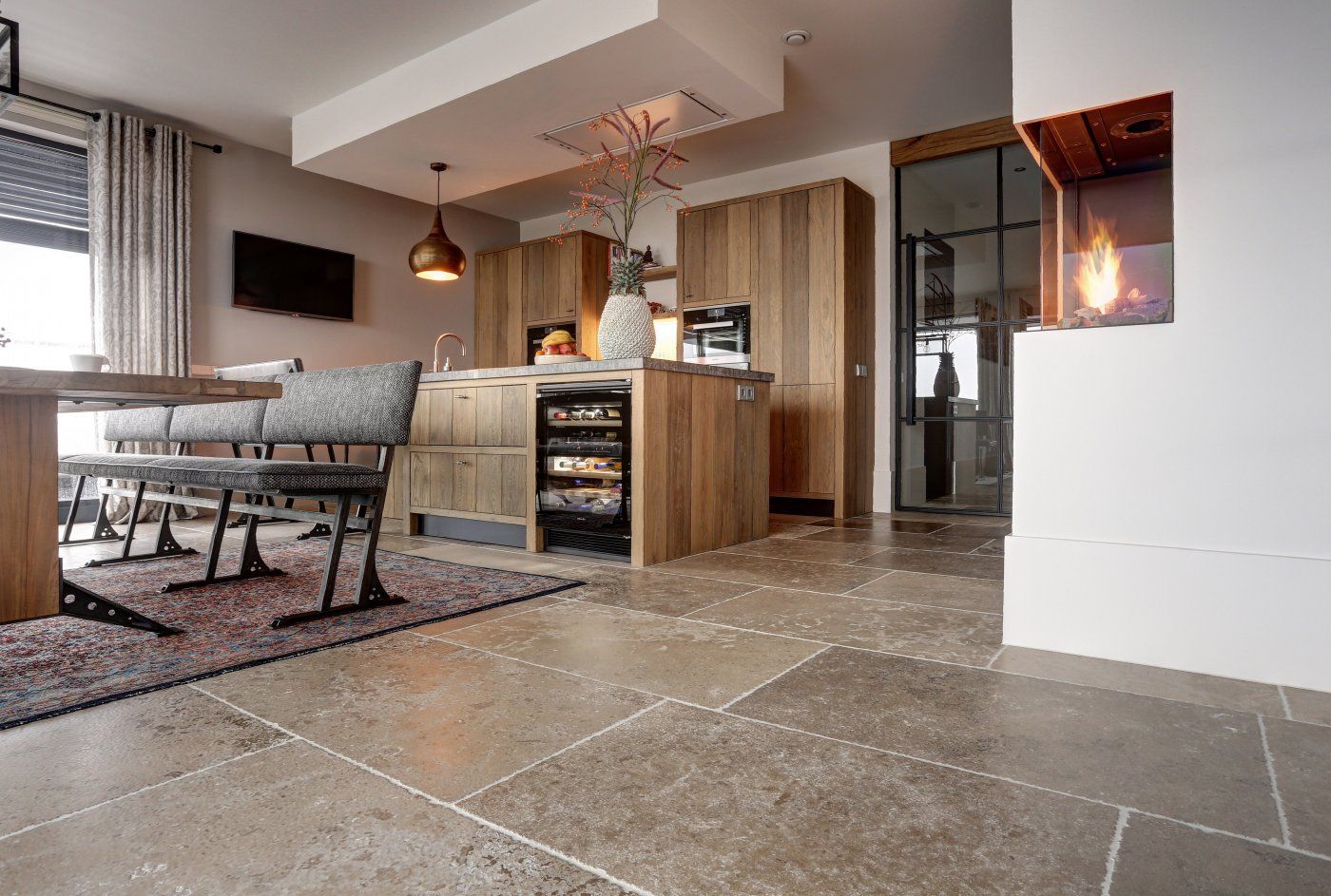 Wohnzimmer mit offener Küche mit Burgunderstein aus Frankreich in Ockernuancen