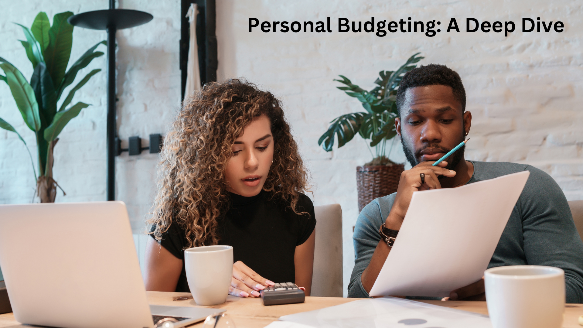 A young couple sitting down and creating a personal budget.