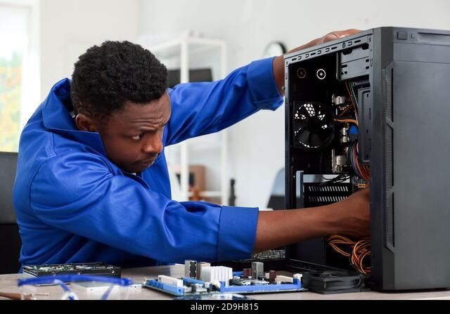 Man sitting at a computer terminal supporting help desk