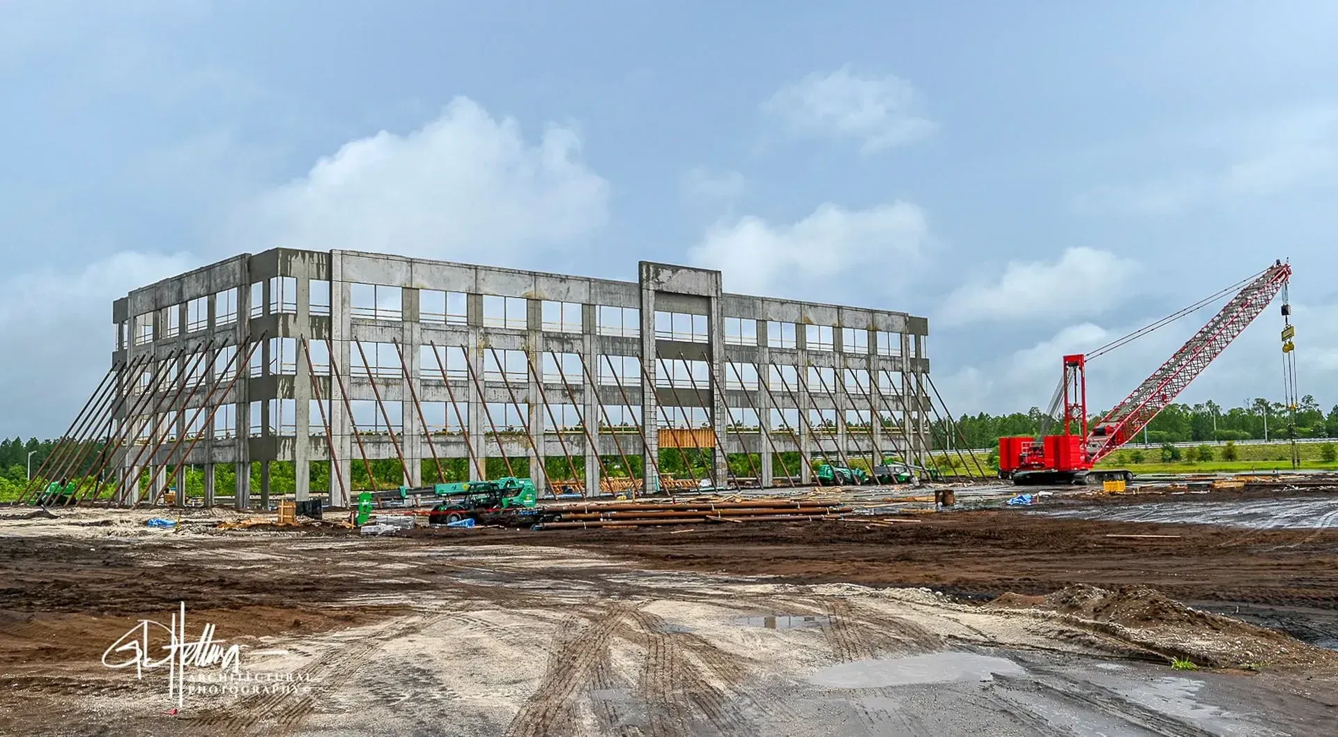 Tilt-up concrete construction phase with reinforced panels and structural lifting operation on site Nocatee FL