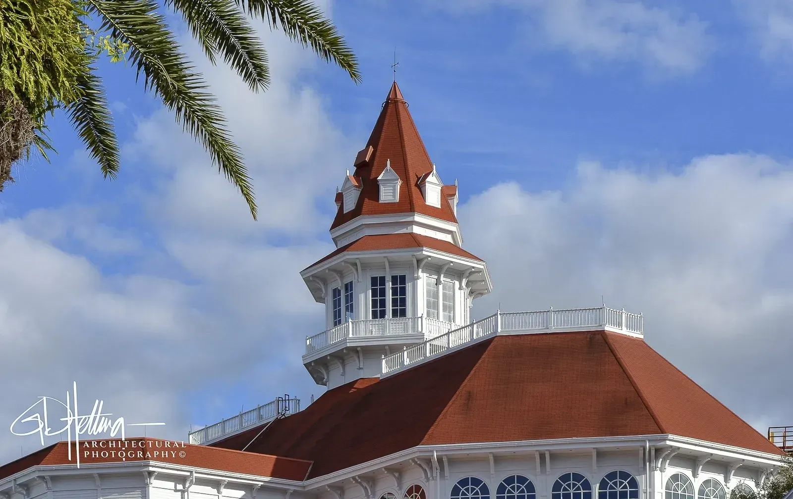 Grand Floridian Hotel exterior with ornate cupola and classic seaside resort architecture.
