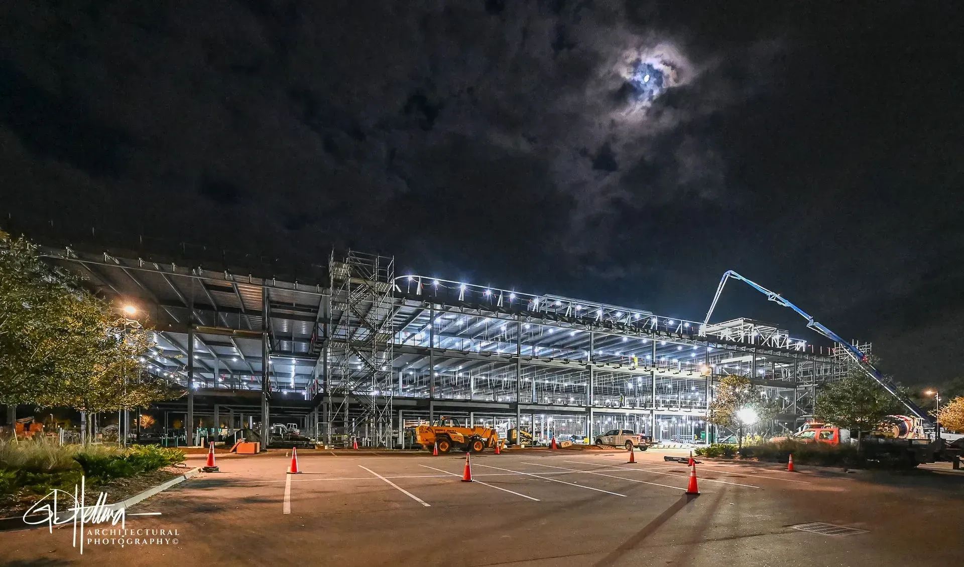 Night time concrete pouring construction activity illuminated site Ponte Vedra Beach FL