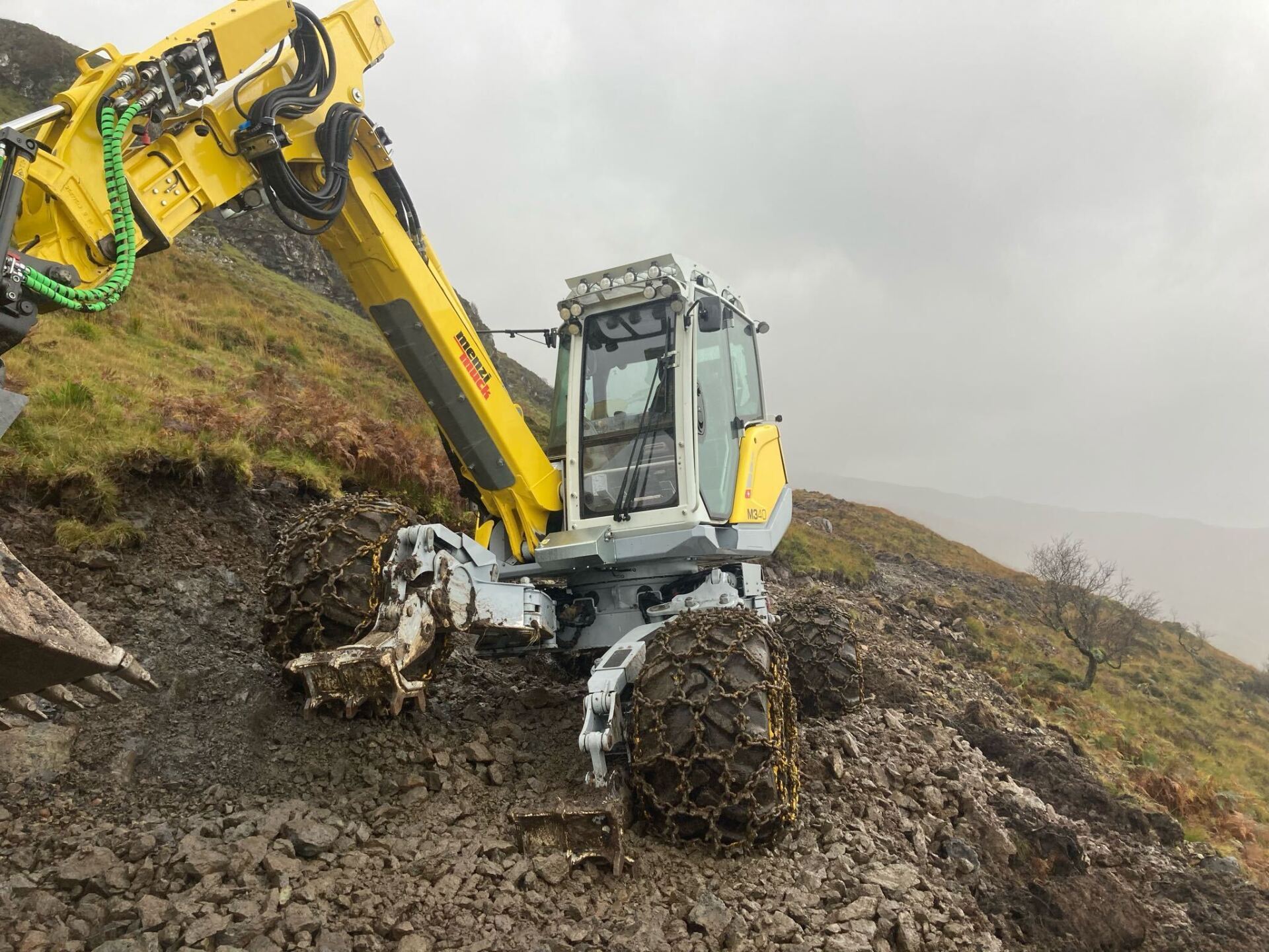 Menzi Muck machine working on ground in Torosay