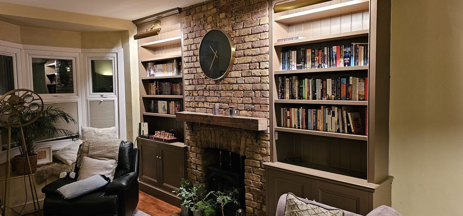 Decorative alcove bookcases and fitted base units built around a chimney breast in Isleworth
