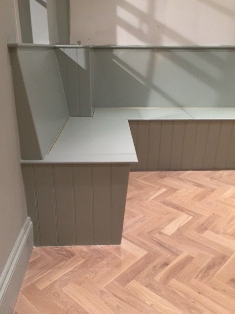 Fitted banquette bench seating with shaker or groove and bead panelling in East Sheen.