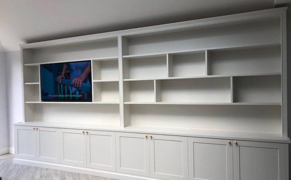 Bespoke media wall with fitted shelving and base cupboards in Strawberry Hill