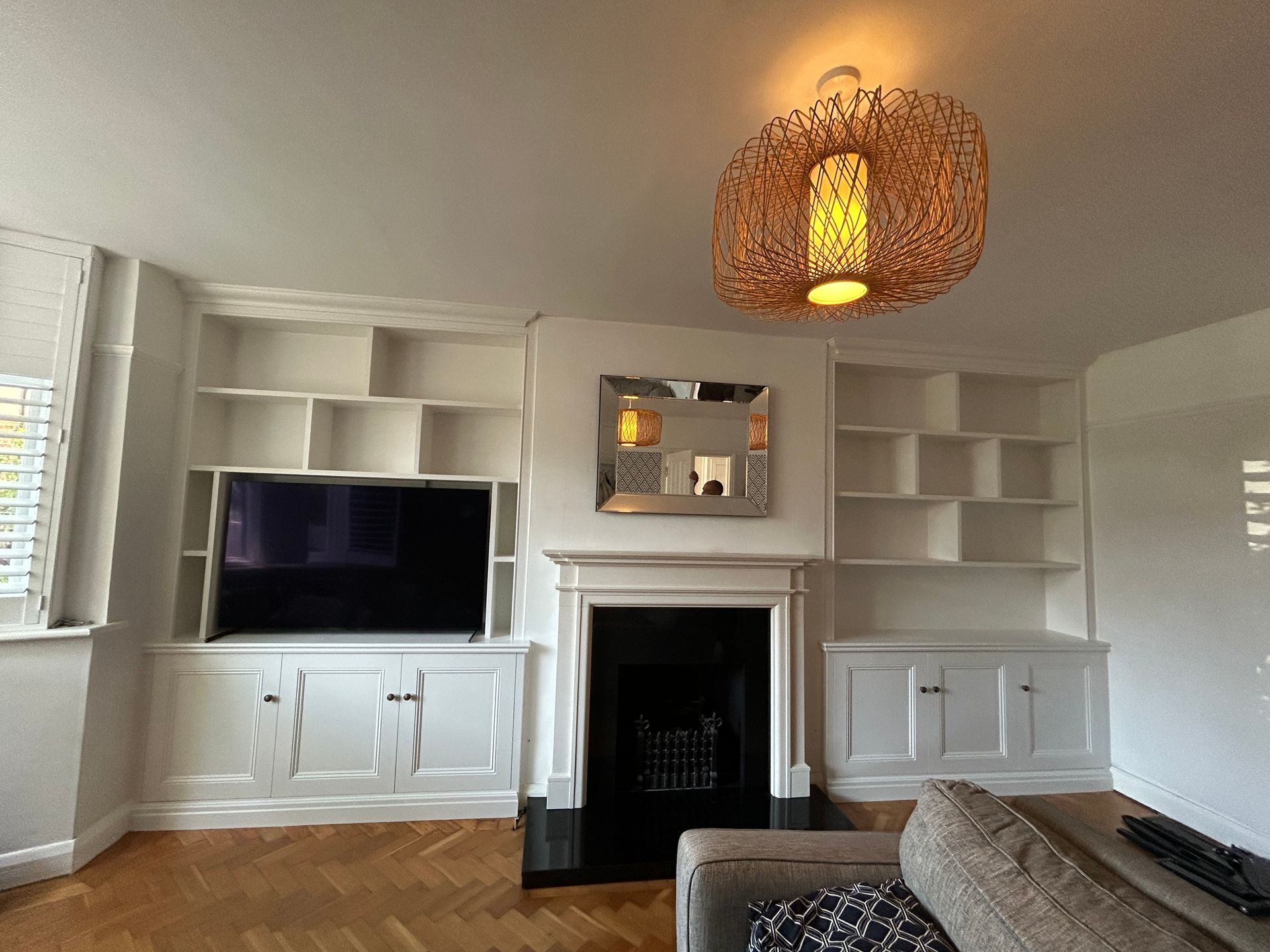 Fitted alcove TV unit with display shelving and three-door alcove cupboards installed in East Sheen