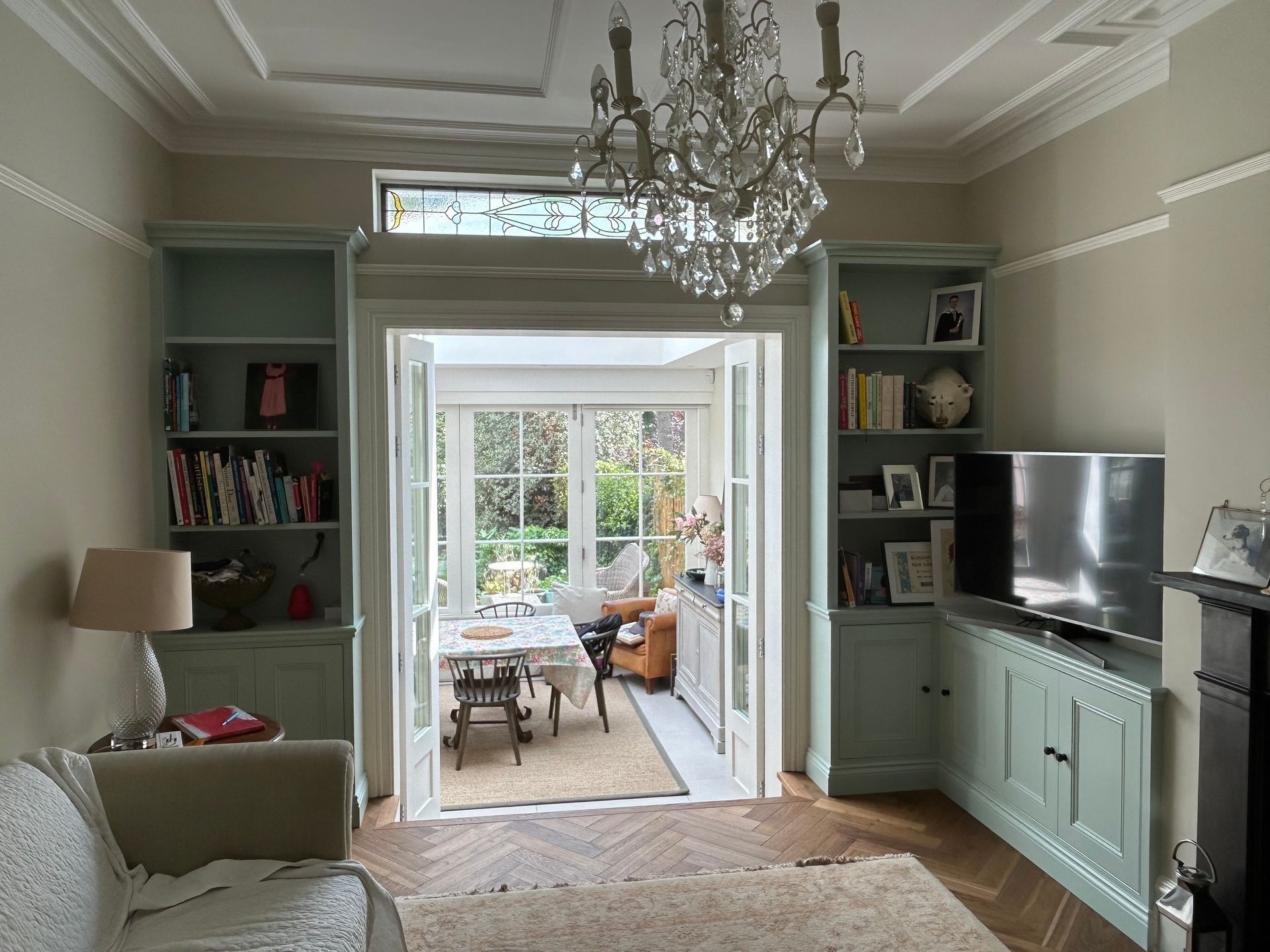 Bespoke alcove cupboards with L-shaped base units and fitted bookcases in Kew