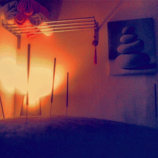 A patient having acupuncture in low light environment room