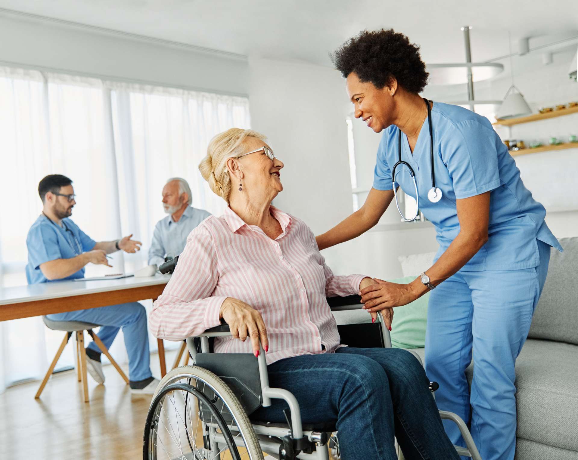 a nurse assisting a patient in a wheelchair