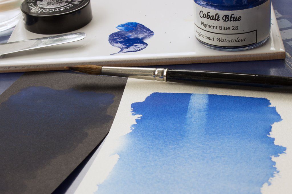 Washes of A J Ludlow Cobalt Blue Professional Watercolour on white and black paper.
