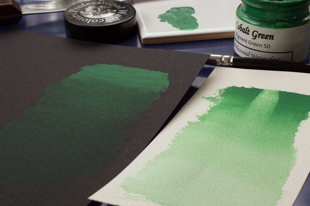 Washes of A J Ludlow Cobalt Green Professional Watercolour on white and black paper.