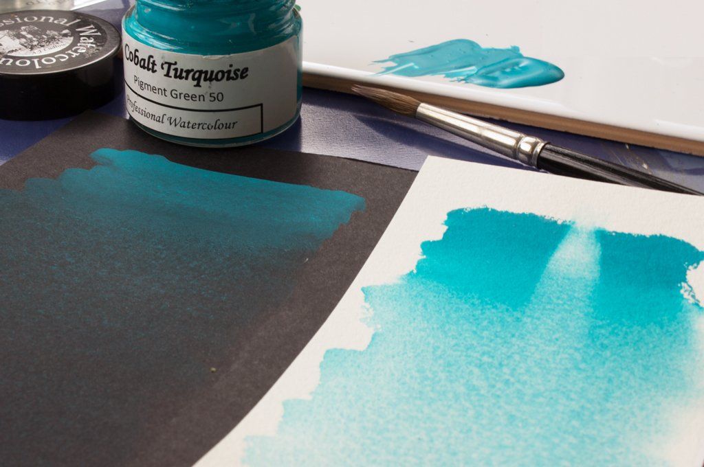 Washes of A J Ludlow Cobalt Turquoise Professional Watercolour on white and black paper.
