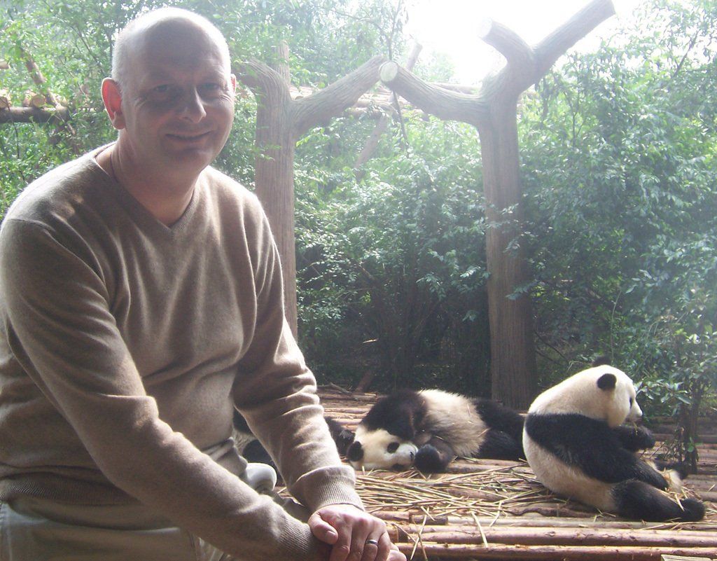 The Author beside the four feeding Giant Pandas Andrew Ludlow at the Chengdu Research Base of Giant Panda Breeding in October 2007