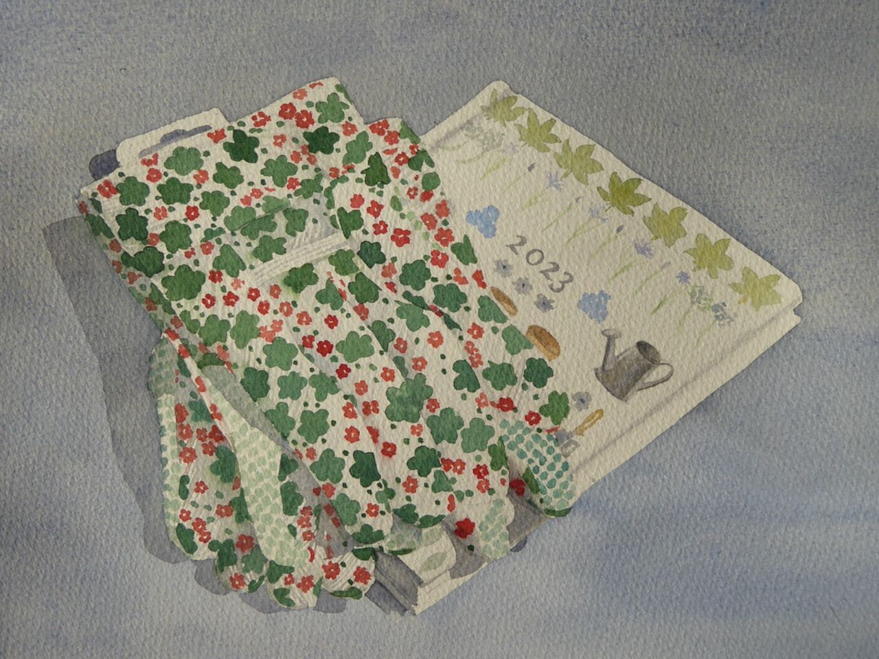 “Gardening Gifts” a watercolour painting of gardening gloves and gardener's diary by Lesley Linley, using A J Ludlow Professional Watercolours