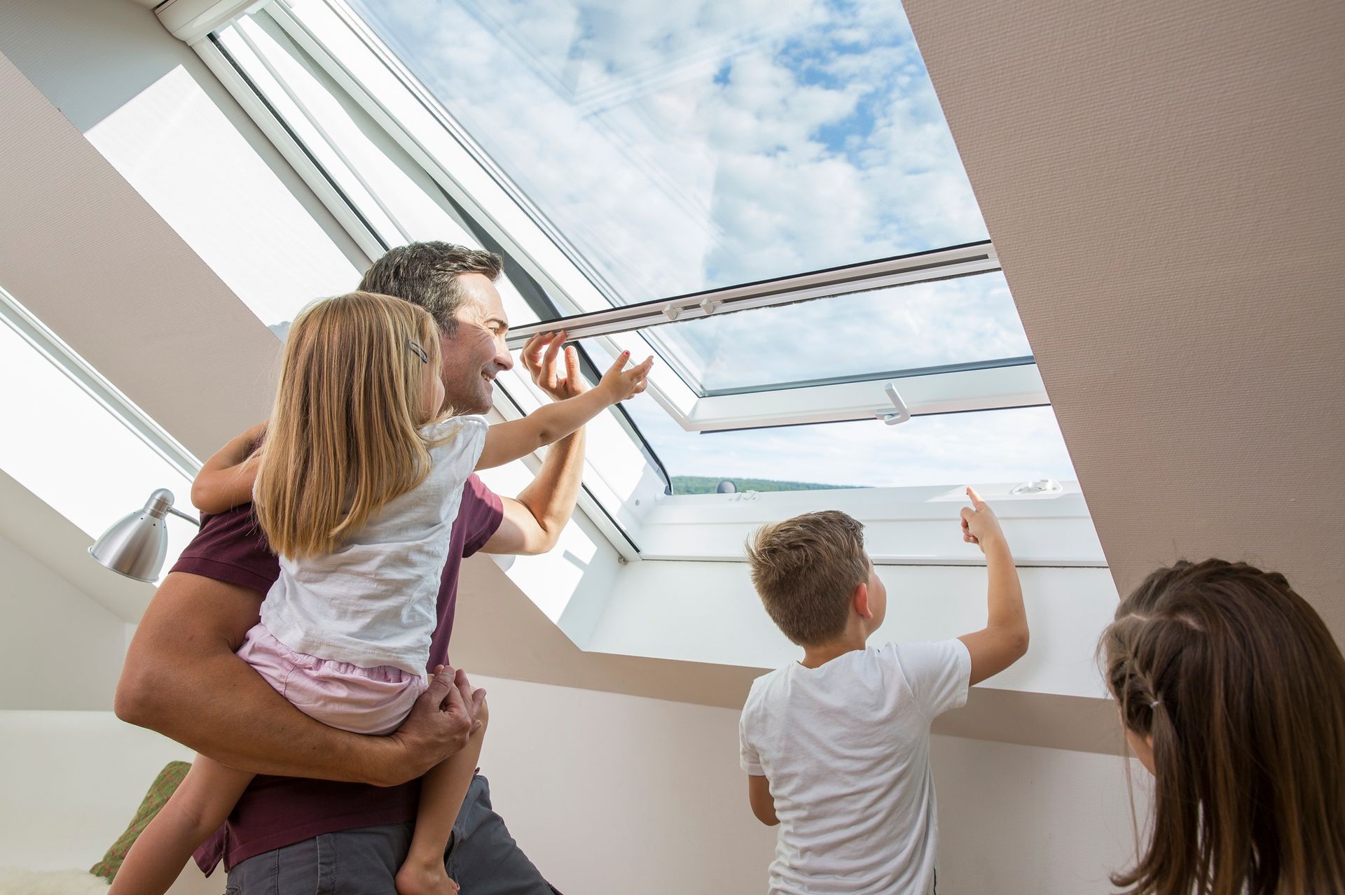 Insect screen roller blind for roof windows by ISK Systeme – reliable insect protection with the roof window open, ideal for families and attic living spaces.