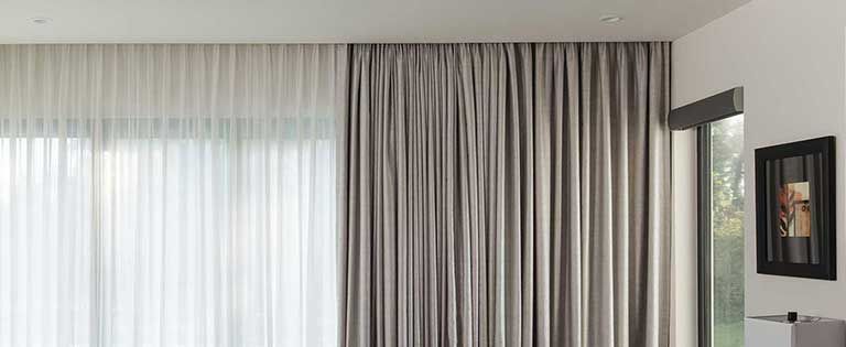 Somfy motorized drapery track mounted to the ceiling