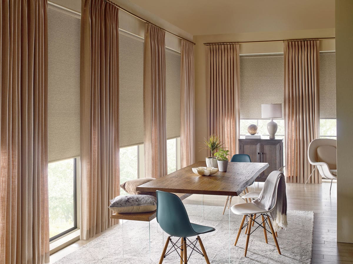 Drapery and roller shades in dining room in Newport Beach