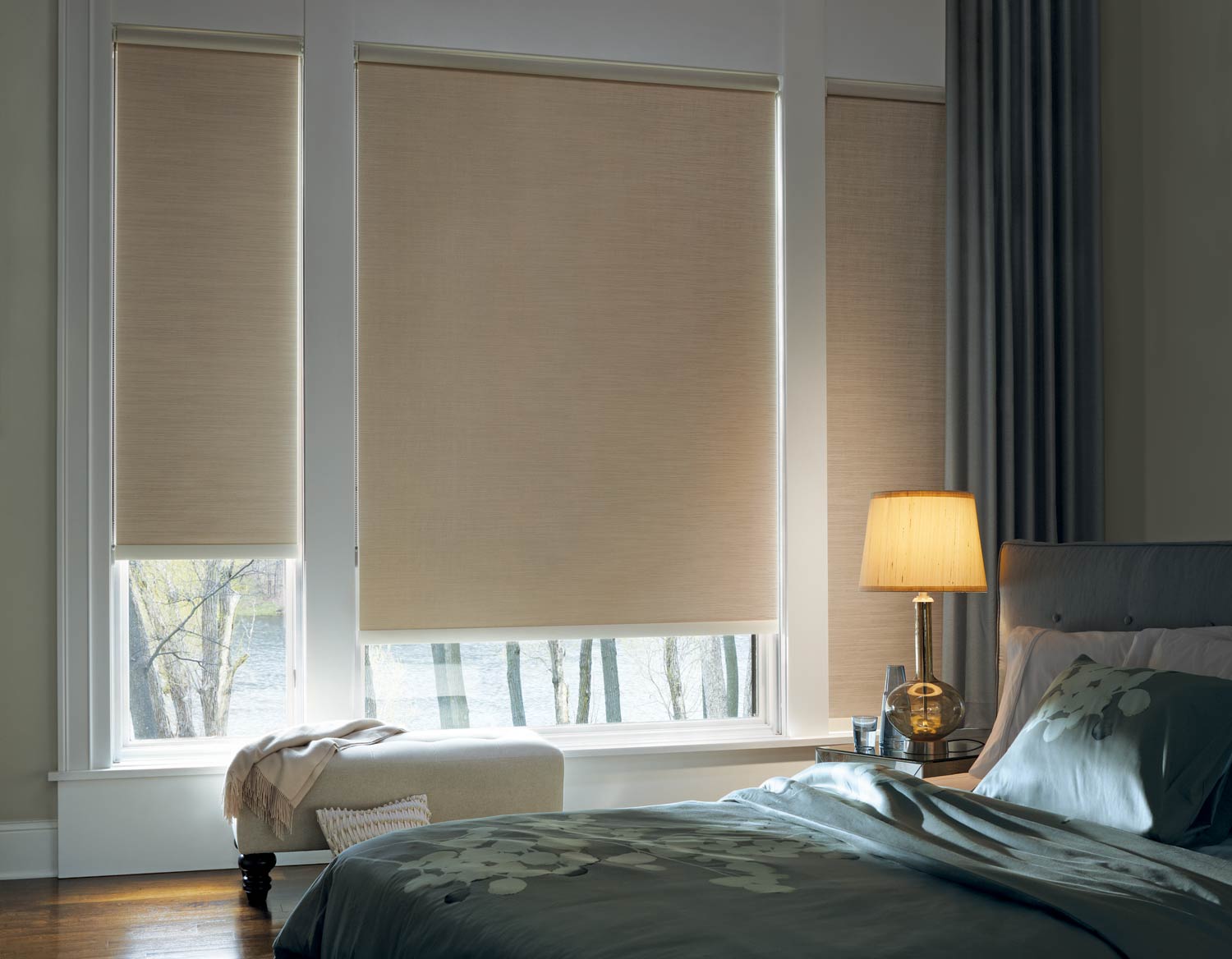 Hunter Douglas Designer Roller Shades beige in a contemporary bedroom Fashion Interiors Irvine