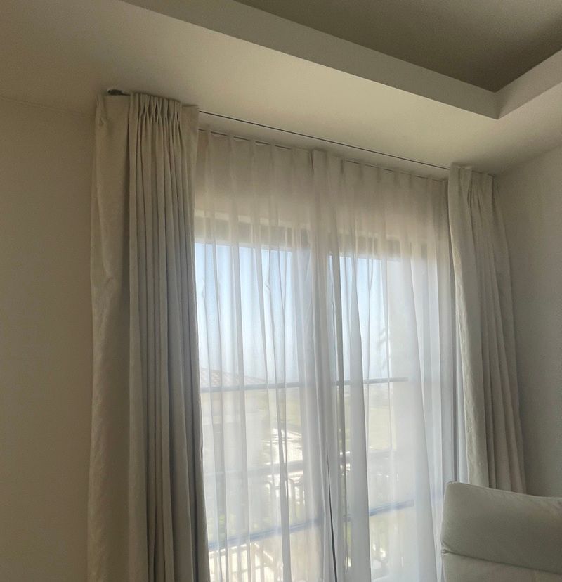 Modern two layered drapery mounted to the ceiling