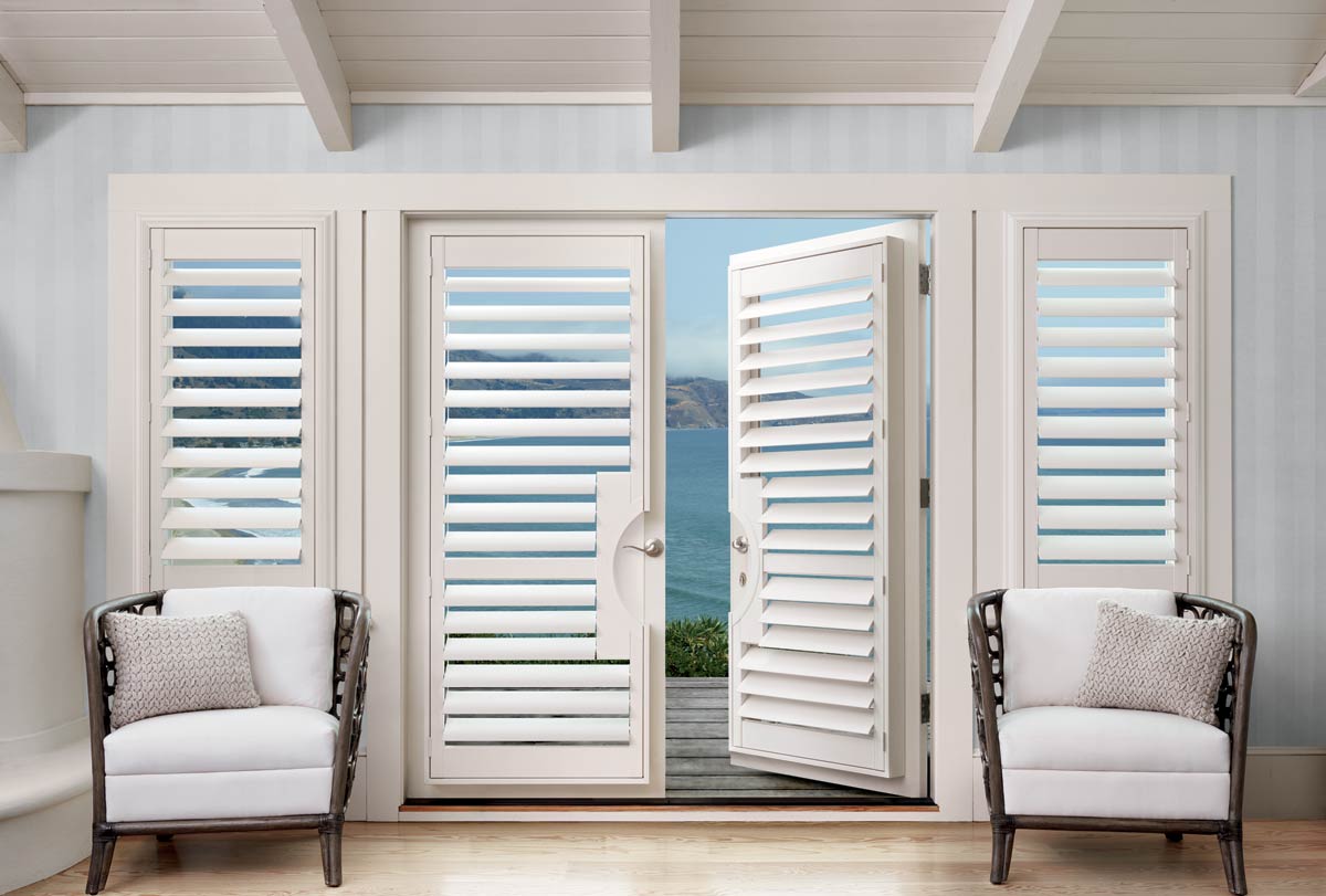 Motorized Hunter Douglas Palmbeach polysatin shutters in contemporary living room beach front by the sea french doors, alexa open my shutters Irvine