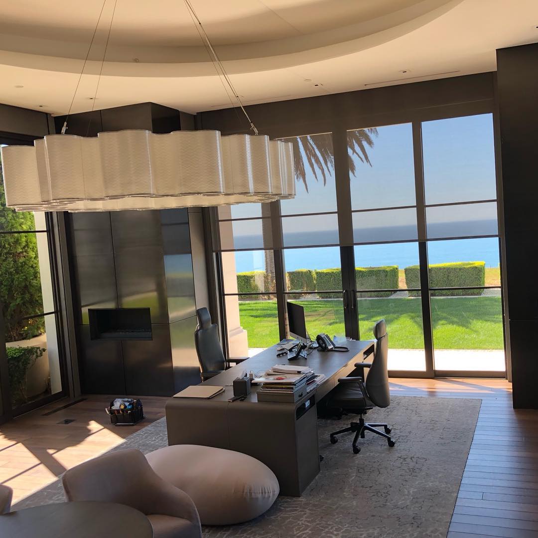 Motorized solar screen shade in modern home office beachfront Irvine