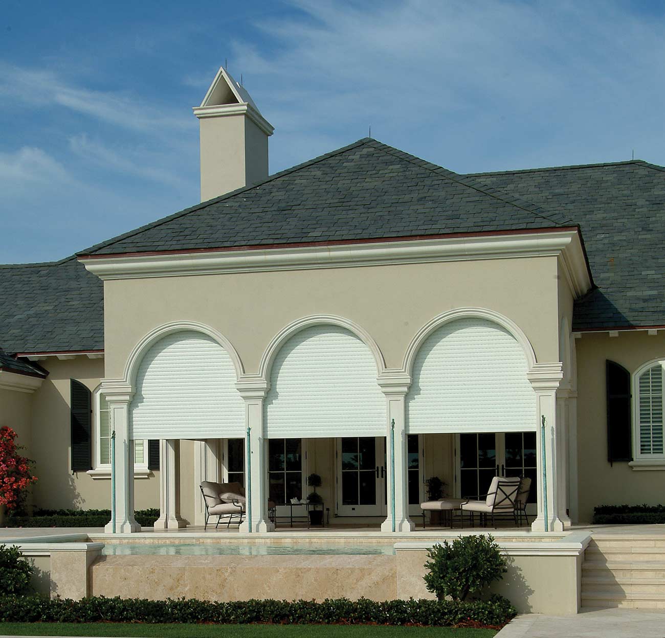 Somfy Motorized Rolling Shutters - Outside view of traditional home Laguna Beach