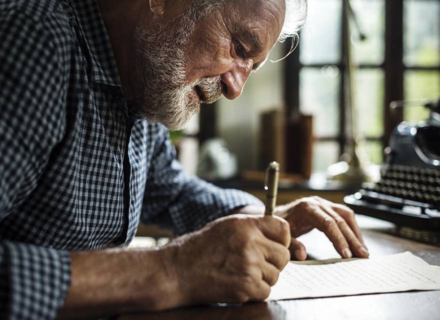 old men writing on a paper