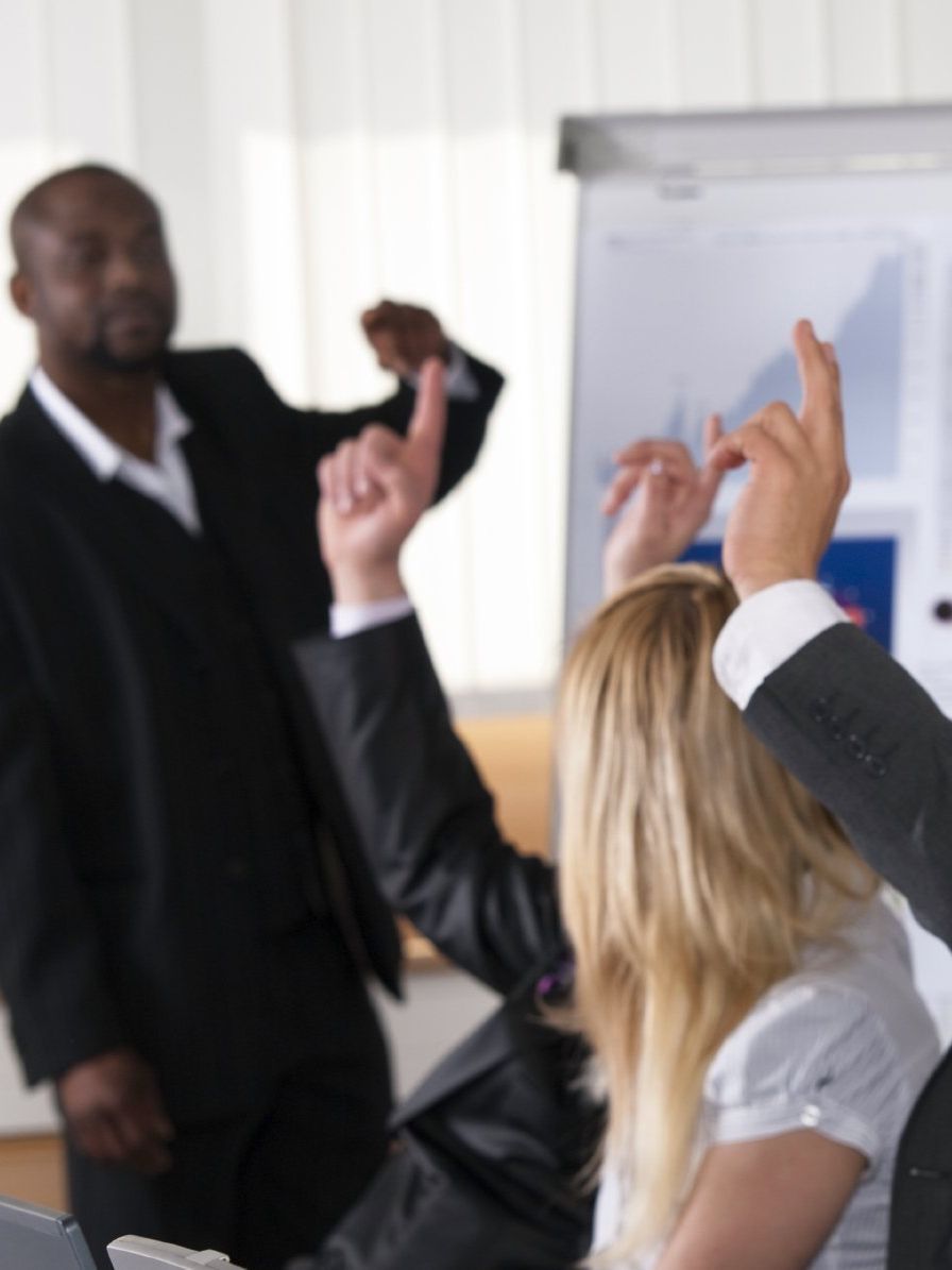 expert instructor teaching ITAM for the cloud to eager students with questions and hands raised