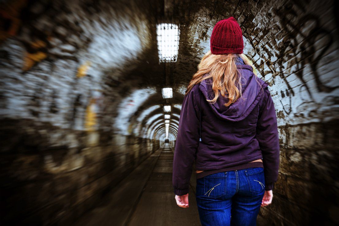 Frau trägt James Notrufuhr von Vitatel sicher alleine nachts unterwegs