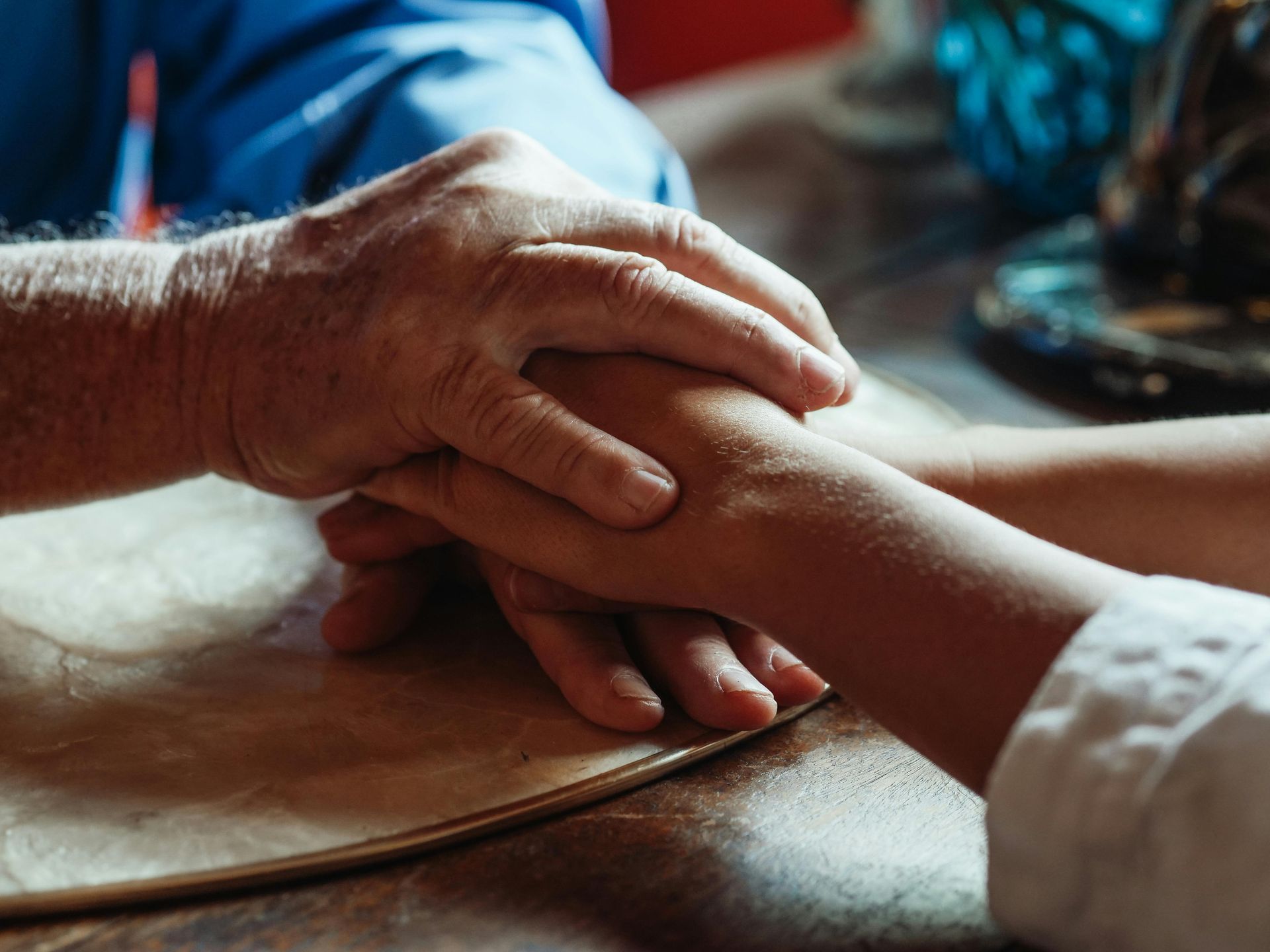 Close up of two pairs of hands on top of one another