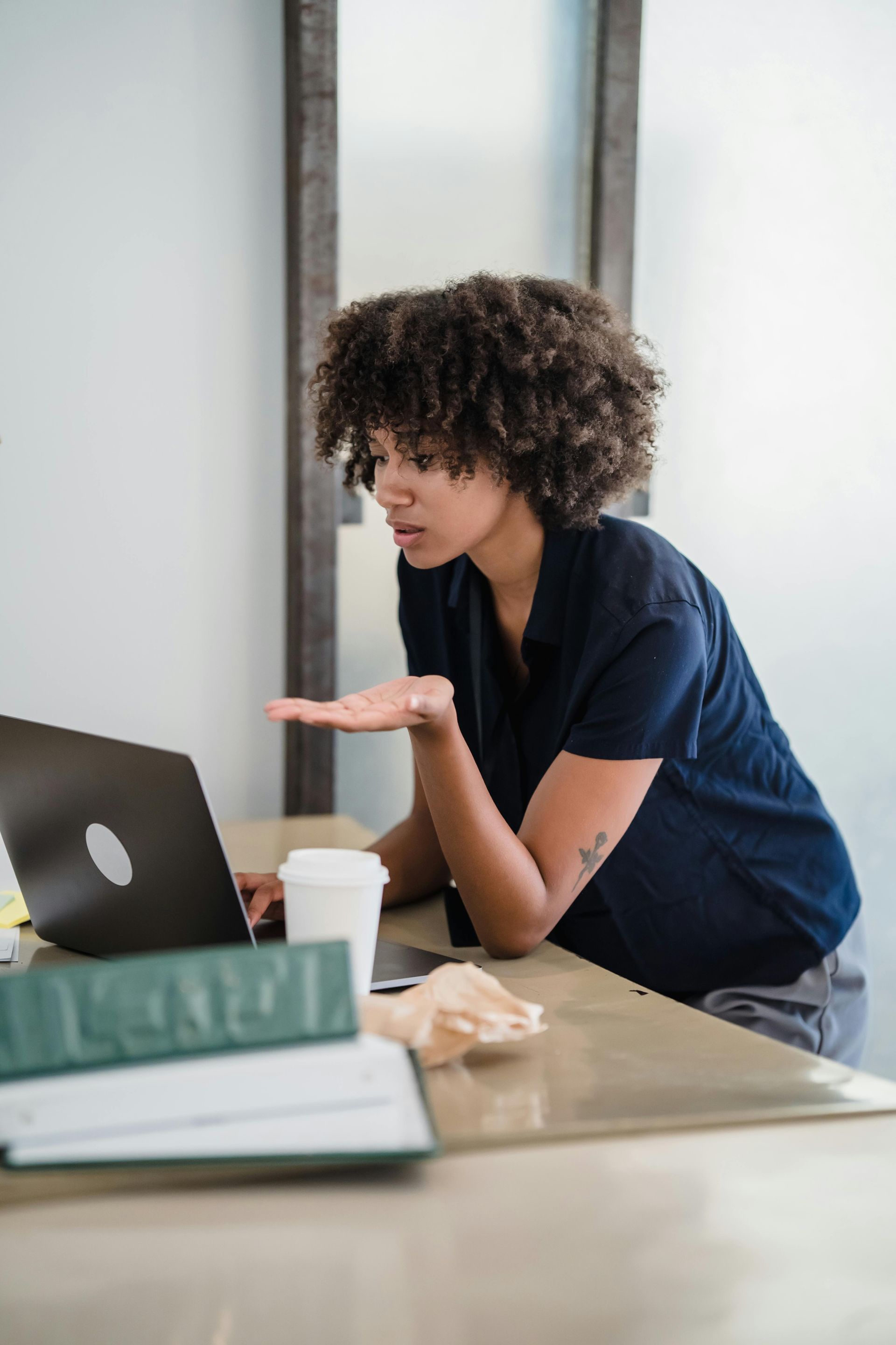 Woman at desk looking at laptop