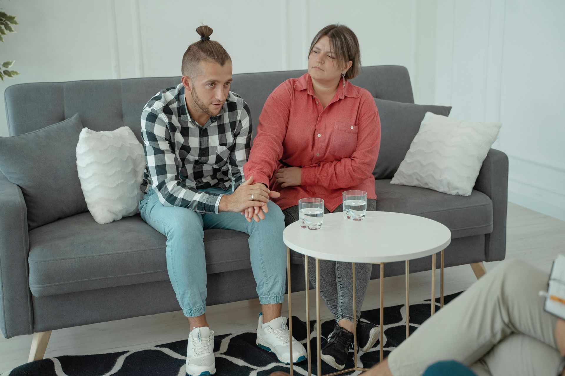 Two people on sofa.