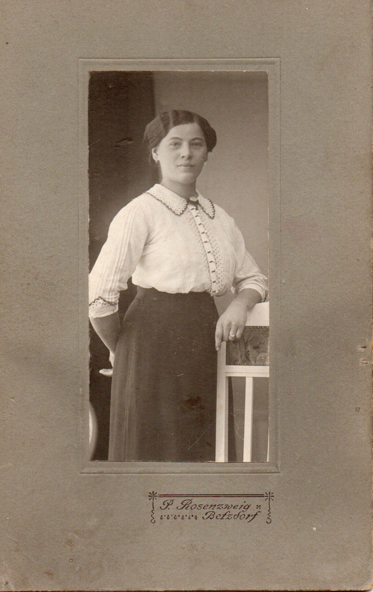 Frau stehend an Lehne Frau stehend an Lehne