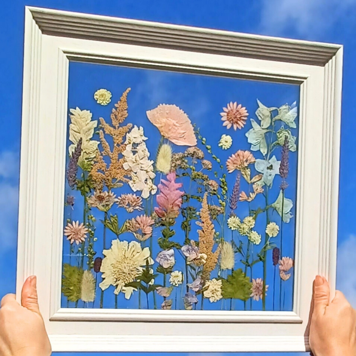 pressed flowers in a meadow design between glass