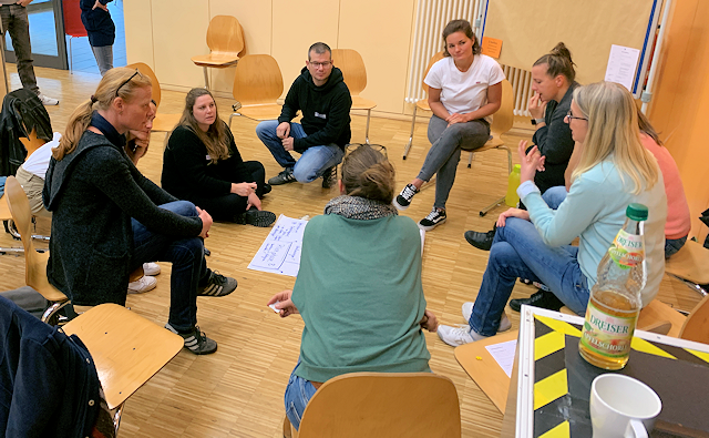 Gruppe von Lehrkräften berät über neue Lösungen im Open Space Gymnasium - Open Space - die Herausforderungen der Digitalisierung gemeinsam bewältigen - Initiativen gründen - Vereinbarungen treffen