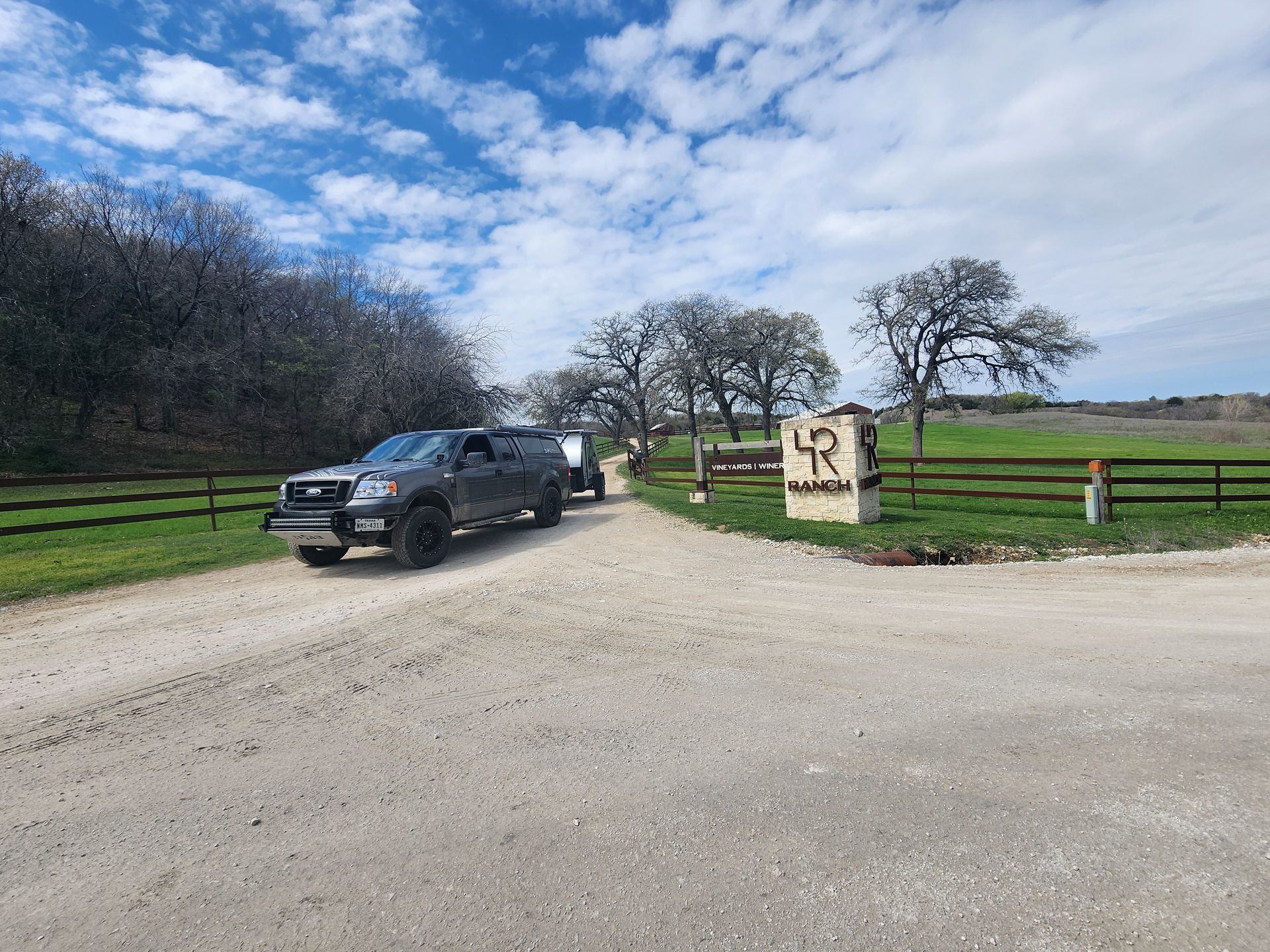 2005 F150 with Braxton Creek Bushwhacker teardrop trailer at the entrance to the 4R Ranch